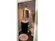 Small, neutral powder room with updated lighting and tile floor with flamingo rug at 7947 Vermont Rd, North Charleston, SC 29418