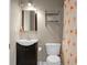 Compact bathroom with gray walls, flamingo shower curtain, stainless steel shelves, and modern mirror at 7947 Vermont Rd, North Charleston, SC 29418