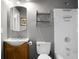 Traditional bathroom with white shower/tub, wood vanity, silver faucet, and framed mirror at 7947 Vermont Rd, North Charleston, SC 29418