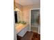 Renovated bathroom with granite countertops, stylish glass vessel sinks, and walk-in shower with glass door at 7947 Vermont Rd, North Charleston, SC 29418