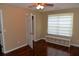 Bright bedroom with hardwood floors, ceiling fan and built-in storage under the large window at 7947 Vermont Rd, North Charleston, SC 29418