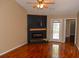 Cozy living room featuring a modern fireplace, wood floors, natural light, and access to an outdoor patio at 7947 Vermont Rd, North Charleston, SC 29418