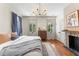 Light-filled bedroom with wood floors, fireplace, and French doors to the outside at 80 Smith St, Charleston, SC 29401