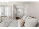 Calm bedroom featuring neutral decor, a plush bed, and soft window lighting with sheer curtains at 80 Smith St, Charleston, SC 29401
