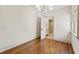 Bright bedroom featuring hardwood floors, chandelier lighting, and an open doorway to the bathroom at 80 Smith St, Charleston, SC 29401