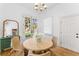 Cozy breakfast nook with round wood table, rattan chairs, and bright view to the backyard at 80 Smith St, Charleston, SC 29401