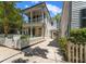 Beautiful home with a white picket fence and a long driveway leading to covered parking at 80 Smith St, Charleston, SC 29401