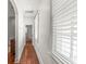 Bright hallway with hardwood floors leading to an arched doorway and window with blinds at 80 Smith St, Charleston, SC 29401