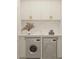 Well-appointed laundry room with white shaker cabinets, marble counters, and modern appliances at 80 Smith St, Charleston, SC 29401