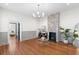 Spacious living room with exposed brick fireplace, hardwood floors, and modern lighting fixture at 80 Smith St, Charleston, SC 29401