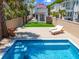 Amazing backyard featuring a pool, lounge chairs, green turf, and landscaping at 80 Smith St, Charleston, SC 29401