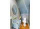 Stylish powder room features custom sink, wood floors and unique design elements at 80 Smith St, Charleston, SC 29401