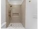 Modern bathroom featuring a tile shower with bronze fixtures and a unique geometric tile floor at 80 Smith St, Charleston, SC 29401