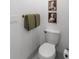 Clean and modern toilet with neutral wall art and bronze towel holder at 80 Smith St, Charleston, SC 29401