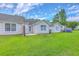 Backyard view showcases a spacious green lawn and partial view of the home's exterior at 8028 Vermont Rd, North Charleston, SC 29418