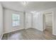 Bright bedroom featuring modern flooring, fresh paint, and ample natural light from the window at 8028 Vermont Rd, North Charleston, SC 29418