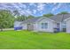 Charming home with a lush green lawn, blue skies, and nice landscaping at 8028 Vermont Rd, North Charleston, SC 29418