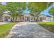 Inviting front exterior with a well-maintained lawn and beautiful trees at 8028 Vermont Rd, North Charleston, SC 29418