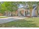 Charming home featuring an inviting front porch, a well-maintained yard, and ample parking space at 8028 Vermont Rd, North Charleston, SC 29418
