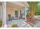 Close-up of front porch with rocking chairs, a well-manicured garden, and a welcoming entrance at 8028 Vermont Rd, North Charleston, SC 29418