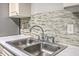 Kitchen sink area featuring sleek faucet and backsplash at 8028 Vermont Rd, North Charleston, SC 29418