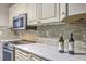 Elegant kitchen featuring marble counters, tiled backsplash, and stainless steel appliances at 8028 Vermont Rd, North Charleston, SC 29418