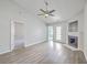 Open living room with fireplace, ceiling fan, and easy access to outdoor patio at 8028 Vermont Rd, North Charleston, SC 29418
