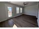 Bedroom featuring a ceiling fan, wood flooring, and natural light from large windows and access to a small patio at 819 Burger St, Charleston, SC 29407