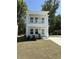 Charming two-story home featuring a welcoming porch and a well-maintained front yard at 819 Burger St, Charleston, SC 29407