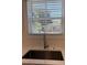 Close up of a stainless steel sink and faucet with tile backsplash at 819 Burger St, Charleston, SC 29407