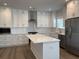 Modern kitchen featuring white cabinets, a center island, and stainless steel appliances at 819 Burger St, Charleston, SC 29407