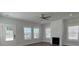 Bright living room featuring modern fireplace, ceiling fan, and abundant natural light at 819 Burger St, Charleston, SC 29407