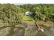 Aerial view of home with private dock, waterfront access, and mature trees offering privacy at 8346 Chisolm Plantation Rd, Edisto Island, SC 29438