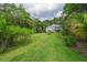 Expansive backyard featuring a well-maintained lawn and mature trees for privacy at 8346 Chisolm Plantation Rd, Edisto Island, SC 29438