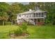 Expansive backyard featuring lush green grass, mature trees, and partial fencing at 8346 Chisolm Plantation Rd, Edisto Island, SC 29438