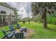 Inviting backyard with mature trees, a seating area, and a charming fire pit for relaxing outdoor gatherings at 8346 Chisolm Plantation Rd, Edisto Island, SC 29438