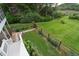 Expansive, fenced backyard with lush greenery, a stone walkway, and a well-kept lawn at 8346 Chisolm Plantation Rd, Edisto Island, SC 29438