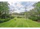 Expansive backyard featuring a lush lawn and serene views of marshland and water at 8346 Chisolm Plantation Rd, Edisto Island, SC 29438