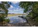 Private boat ramp with wooden dock, offering direct access to tranquil waters at 8346 Chisolm Plantation Rd, Edisto Island, SC 29438