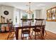 Charming dining room with wood floors, a chandelier, and a bay window at 8346 Chisolm Plantation Rd, Edisto Island, SC 29438