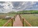 Picturesque view from dock, framed by wooden railings, overlooks tranquil marshland at 8346 Chisolm Plantation Rd, Edisto Island, SC 29438