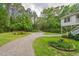 Long gravel driveway leading to a charming home surrounded by lush greenery at 8346 Chisolm Plantation Rd, Edisto Island, SC 29438