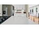 Modern kitchen with stainless steel appliances, white cabinets, quartz countertops, and an island at 8346 Chisolm Plantation Rd, Edisto Island, SC 29438