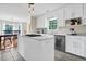 Contemporary kitchen with white cabinetry, stone countertops, stainless steel appliances, and an island with range at 8346 Chisolm Plantation Rd, Edisto Island, SC 29438