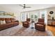 Comfortable living room area featuring plush seating, hardwood floors, and a view of the outdoor scenery at 8346 Chisolm Plantation Rd, Edisto Island, SC 29438