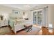 Cozy main bedroom with hardwood floors and sliding door leading to the deck at 8346 Chisolm Plantation Rd, Edisto Island, SC 29438