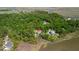 Aerial view of a house nestled among trees with access to the waterfront, showcasing its serene location at 8970 Palmetto Rd, Edisto Island, SC 29438