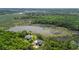 Captivating aerial view showcases home near a serene lake and surrounded by lush greenery and marshlands at 8970 Palmetto Rd, Edisto Island, SC 29438