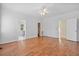Spacious bedroom with ceiling fan, neutral walls, wood floors and walk in closet at 8970 Palmetto Rd, Edisto Island, SC 29438