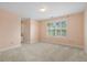 Cozy bedroom with neutral carpet, large window, and ample natural light at 8970 Palmetto Rd, Edisto Island, SC 29438